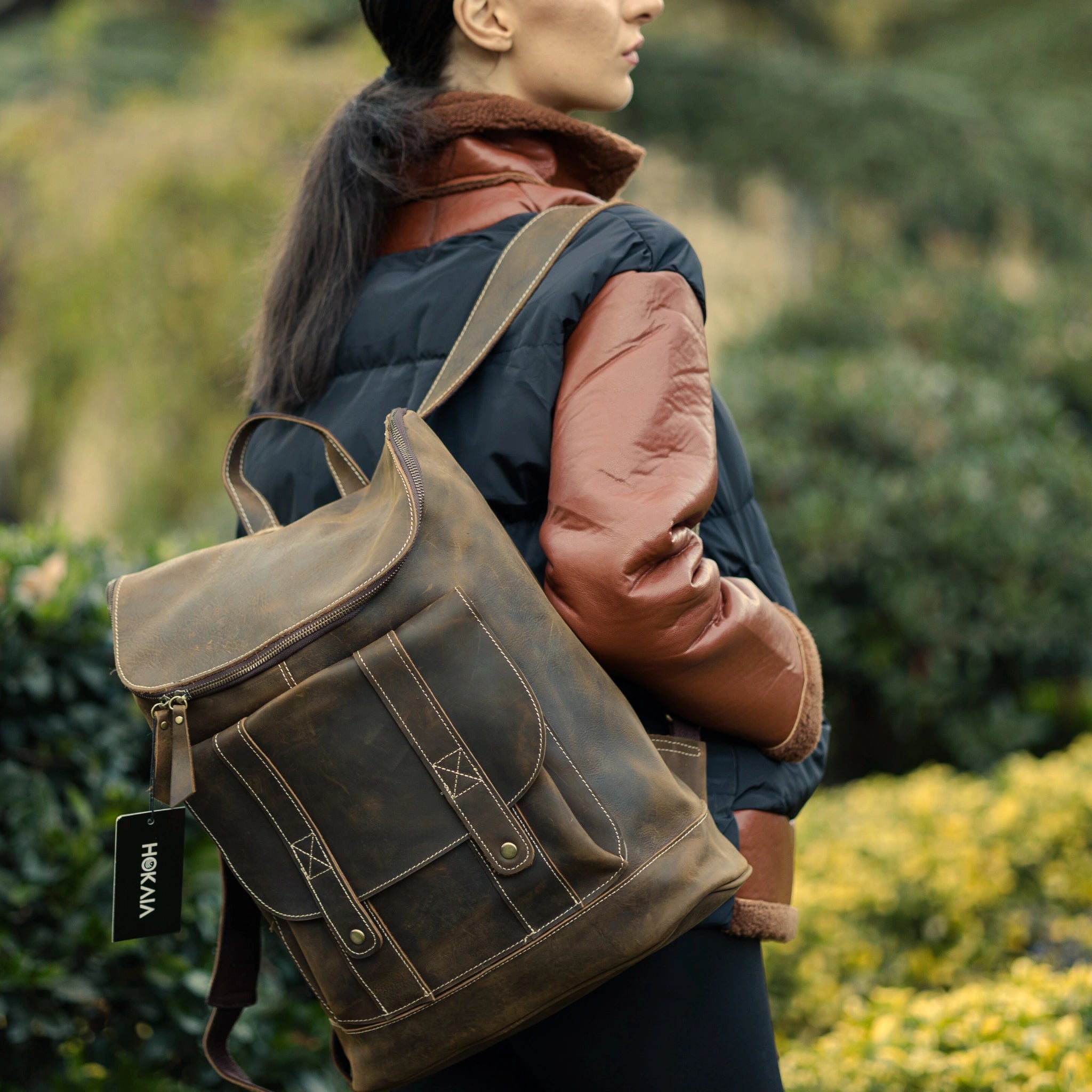 model wearing cognac brown backpack