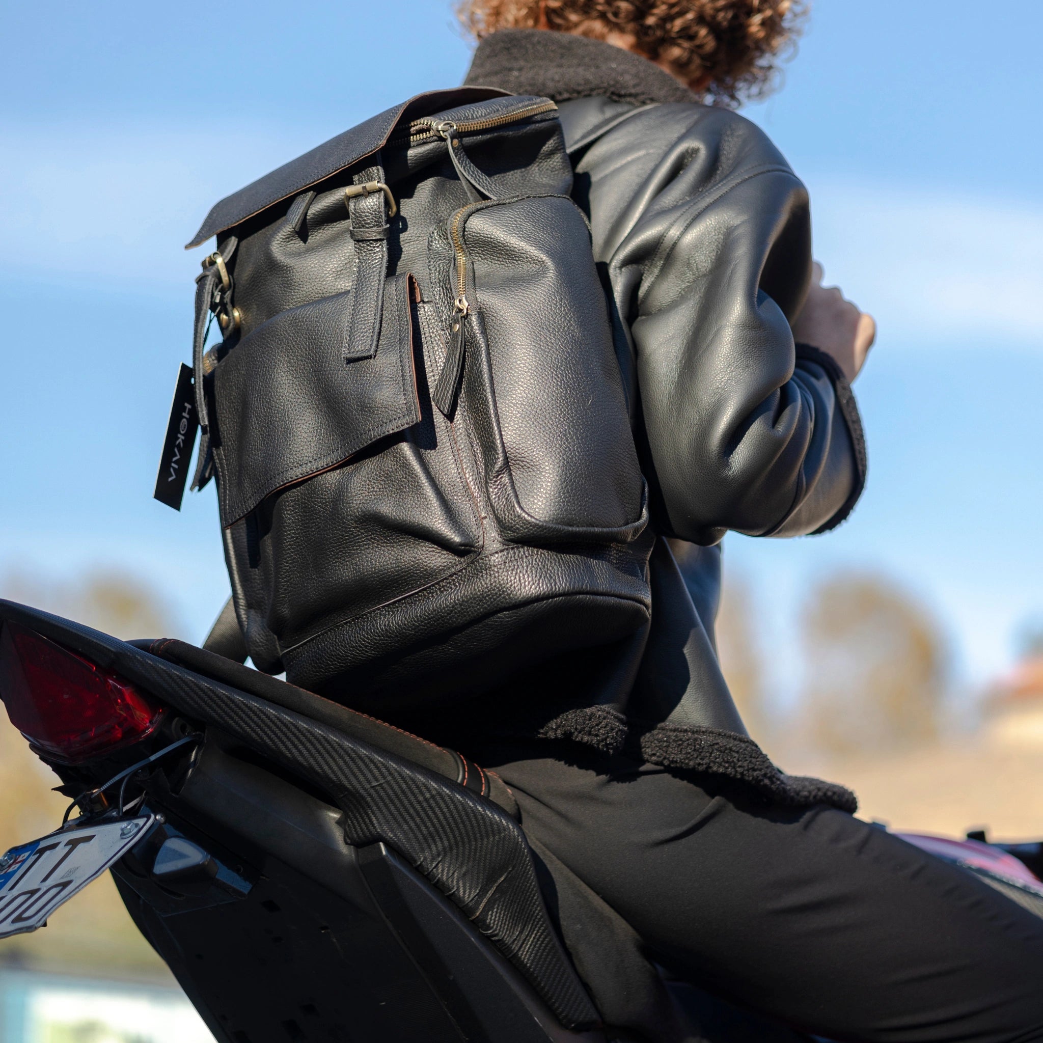 model wearing Hokaia Full Grain Black Leather Backpack