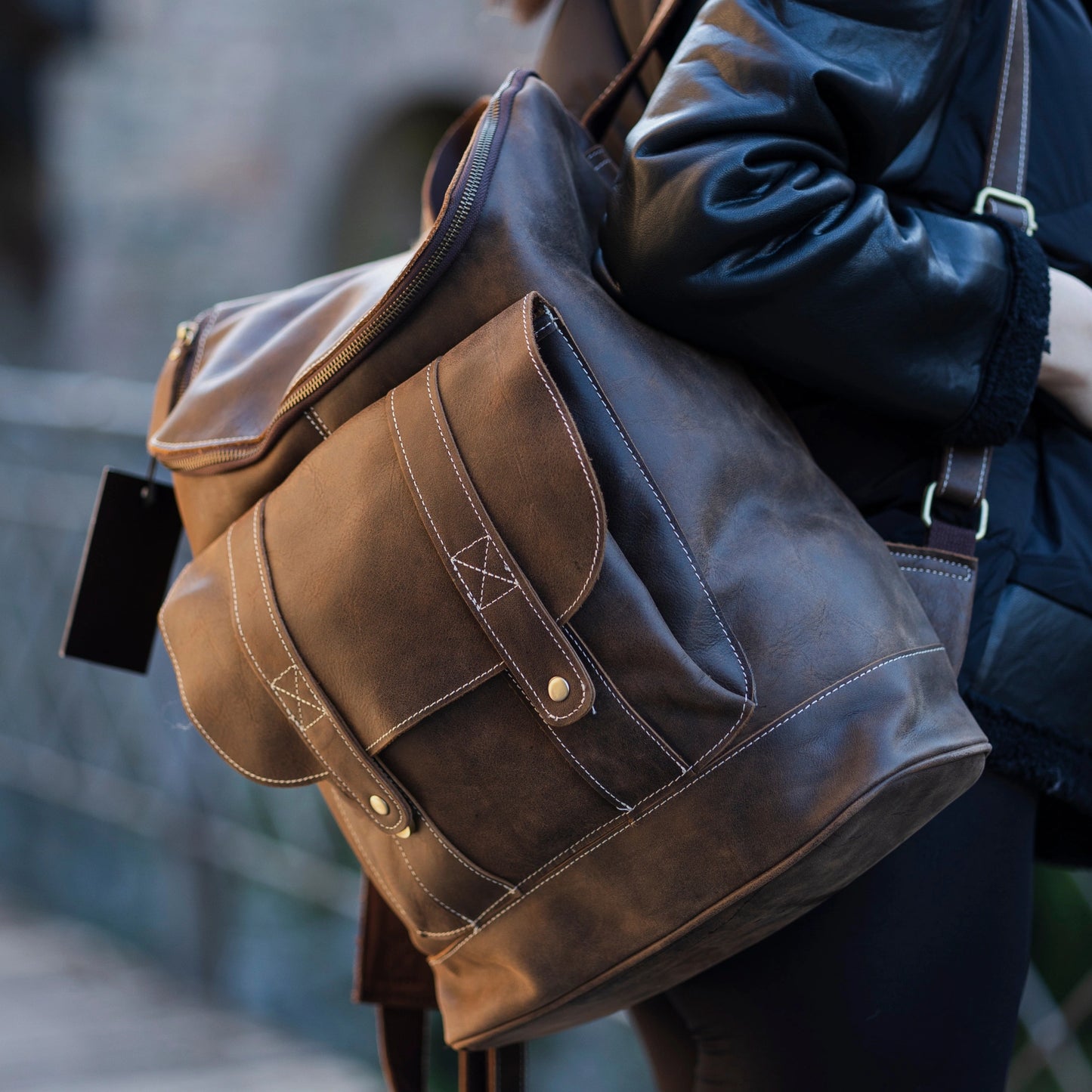 model wearing Hokaia Full Grain Leather Backpack